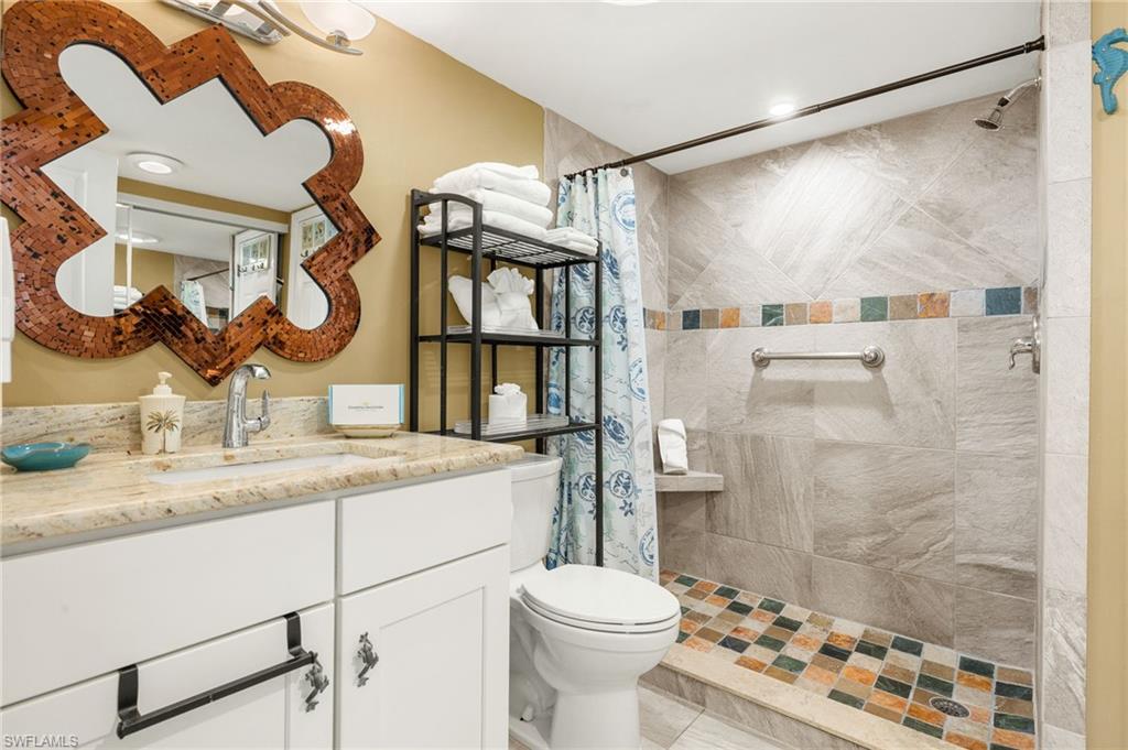 Full bathroom with vanity, a shower stall, and recessed lighting