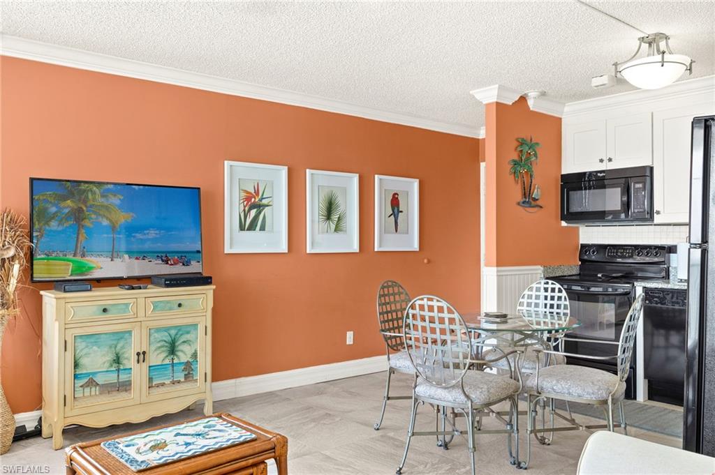 Dining room featuring crown molding and a textured ceiling