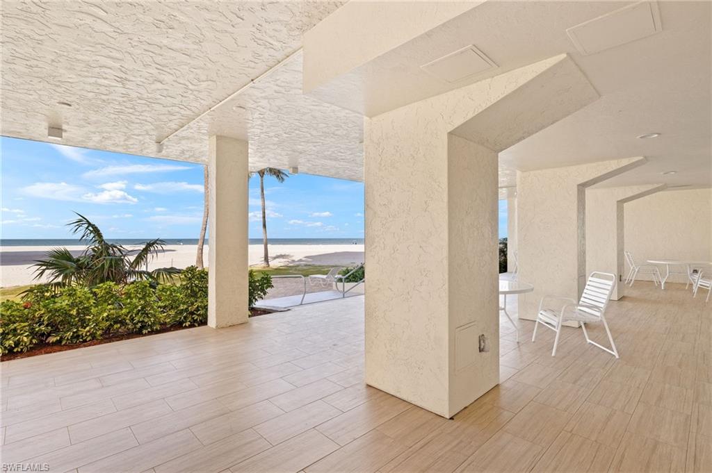 View of patio / terrace with view of water and beach
