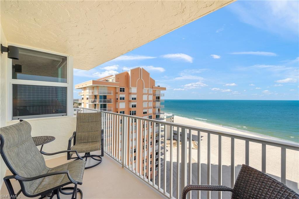 Balcony with view of water and beach