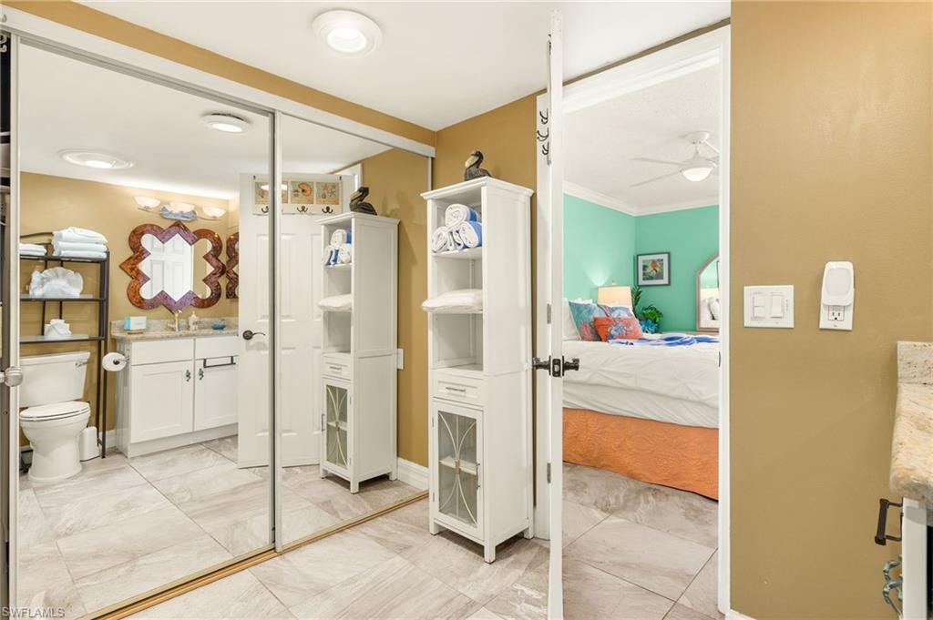 Bathroom featuring vanity, ensuite bath, and a ceiling fan
