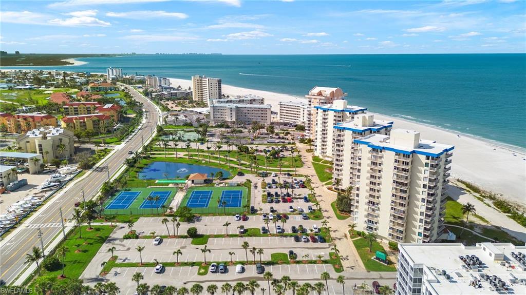 Bird's eye view of unending shoreline and apartment complex