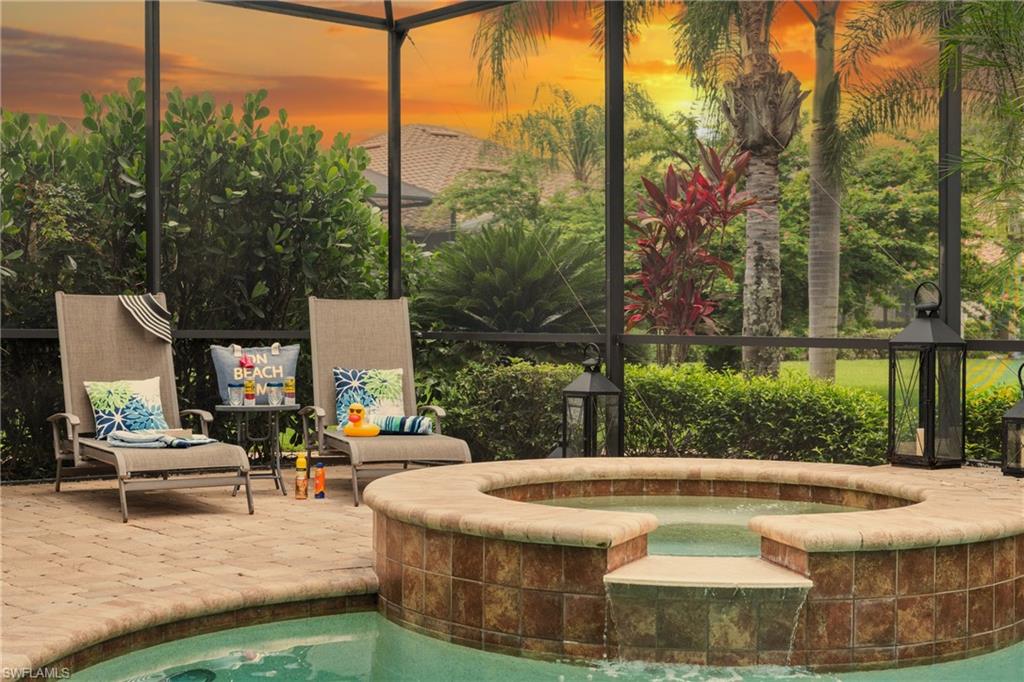 Outdoor pool with an in-ground hot tub and a patio
