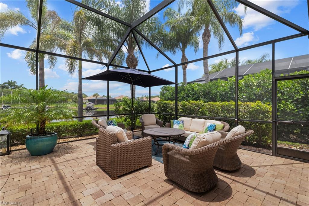 View of patio with outdoor seating, a sunroom, and a lanai
