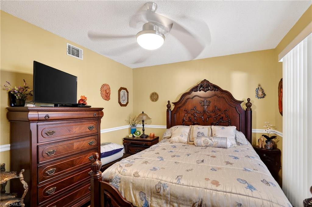 Bedroom featuring ceiling fan and a textured ceiling
