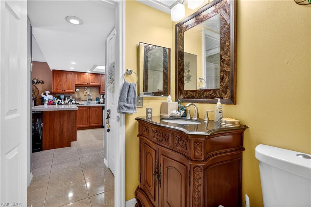 Half bath featuring vanity, recessed lighting, and light tile patterned floors
