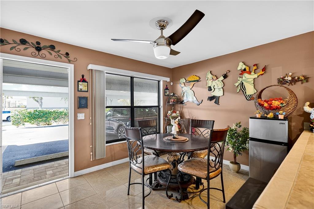 Dining room with ceiling fan and light tile patterned floors
