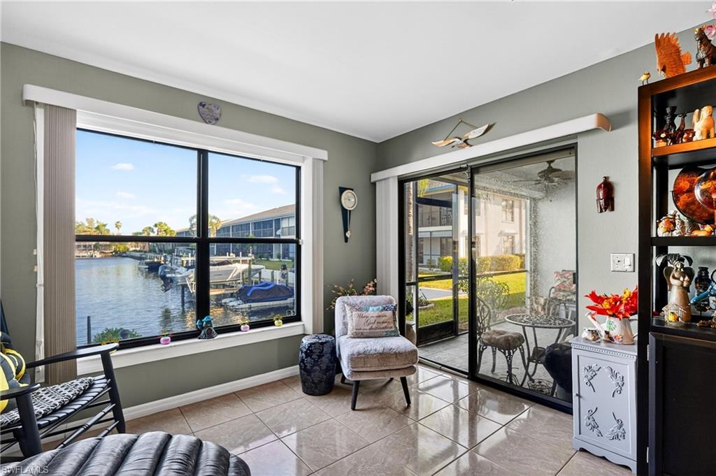 Sitting room with a water view and light tile patterned floors
