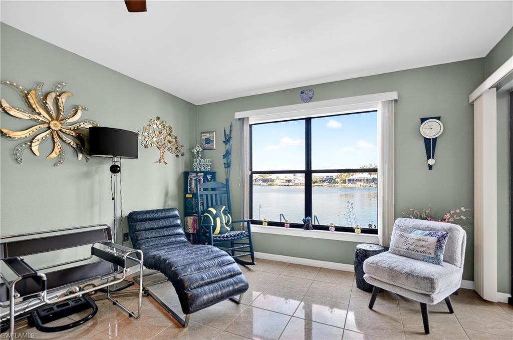 Living area with a water view and light tile patterned flooring