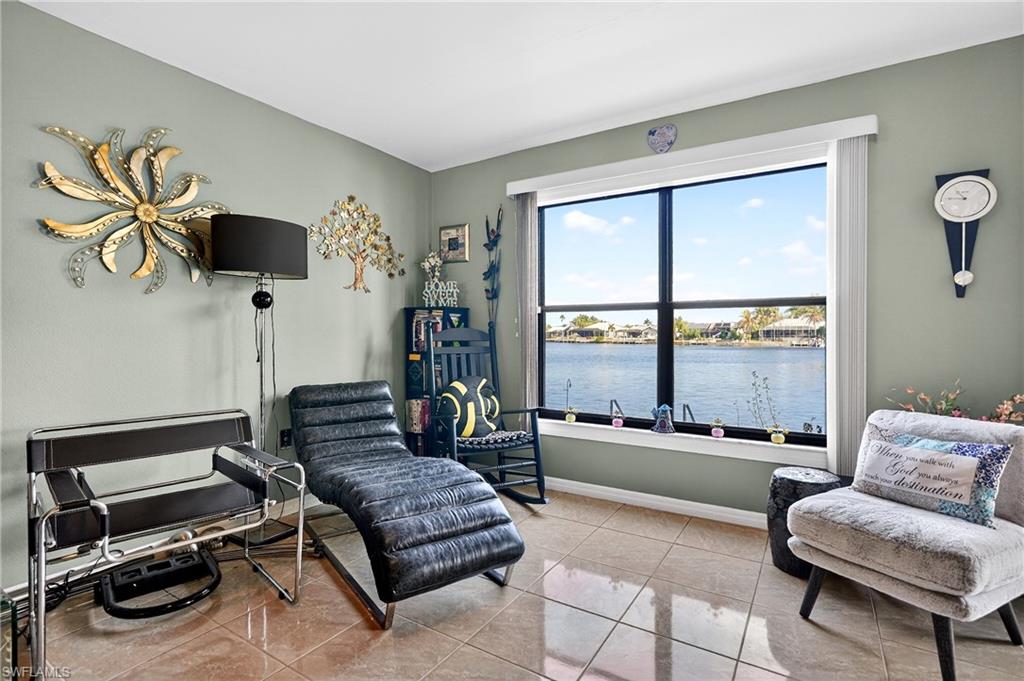 Sitting room with a water view and light tile patterned flooring