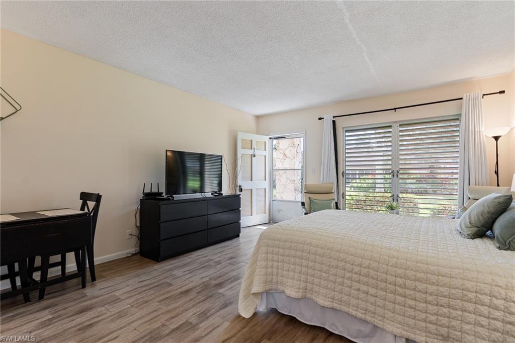 Bedroom featuring light wood-style flooring and a textured ceiling