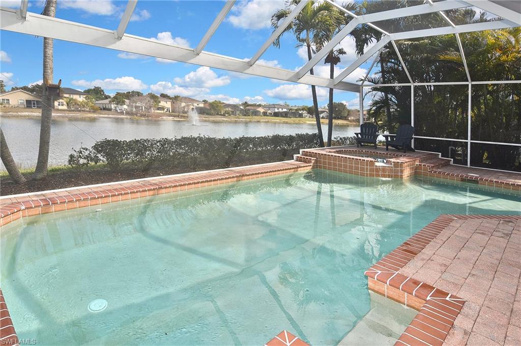 Integrated pool / spa featuring a residential view, a sunroom, a lanai, a patio area, and a water view