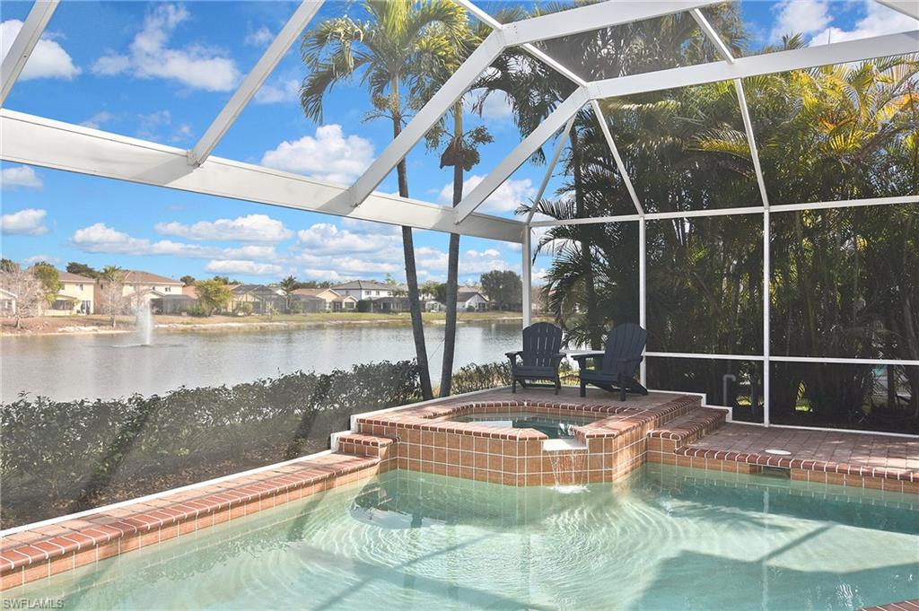 Relaxing pool / spa featuring a residential view, a lanai, and a water view