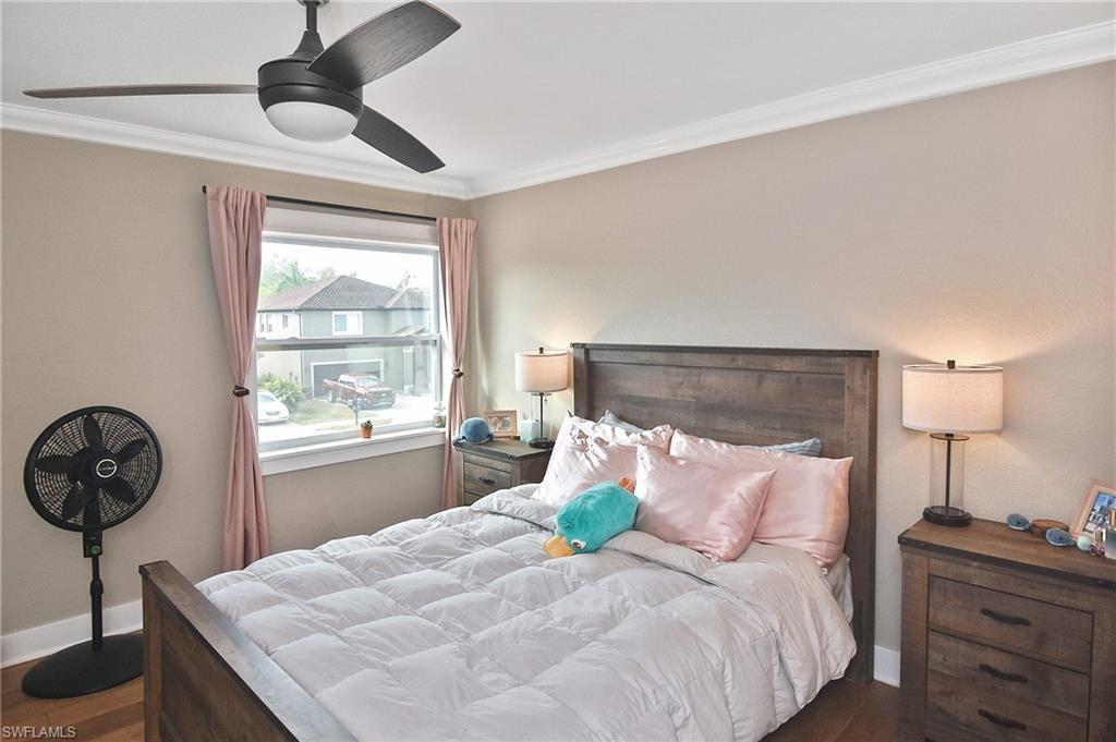 Bedroom featuring ornamental molding, ceiling fan, and wood finished floors