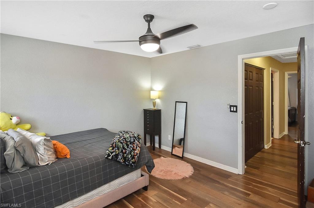 Bedroom featuring dark wood-style flooring and ceiling fan