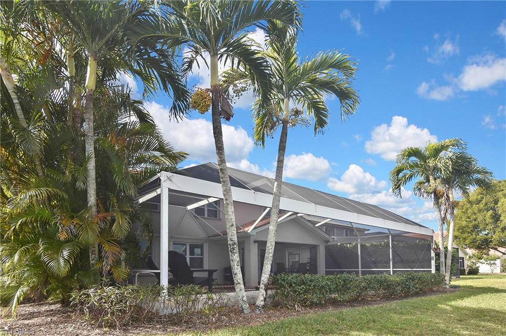 Rear view of property with a sunroom and glass enclosure