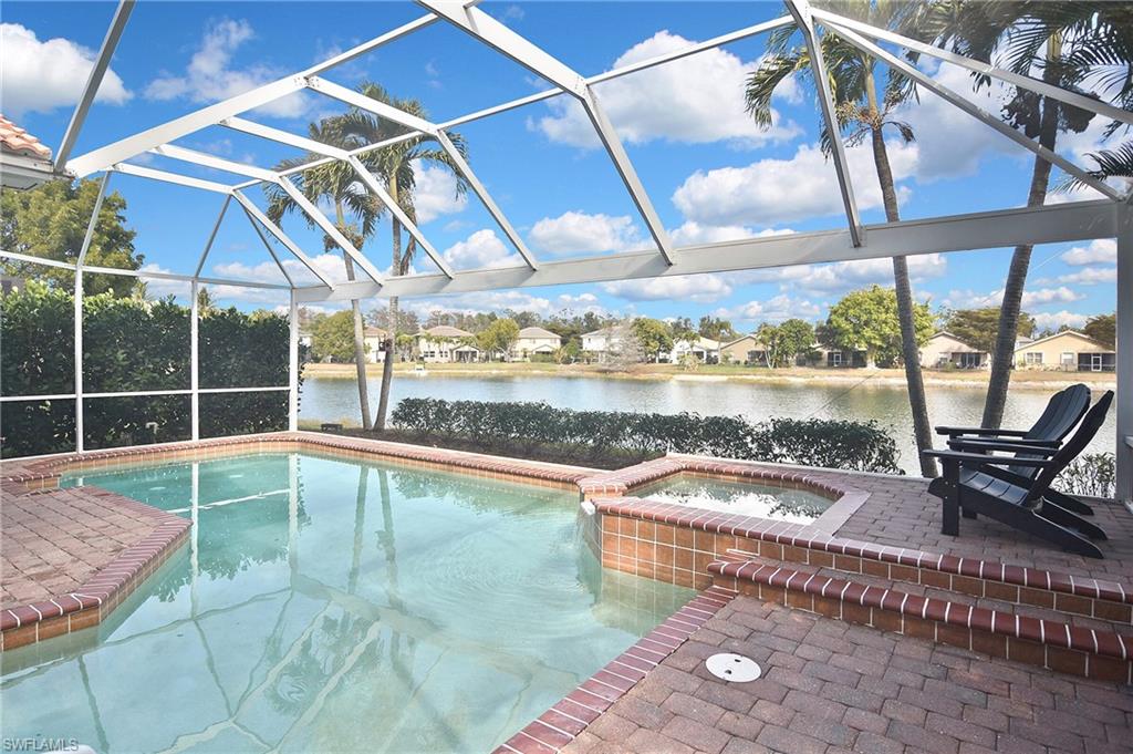 Integrated pool / hot tub with a residential view, a water view, a sunroom, a patio area, and a lanai