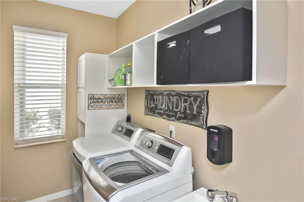 Laundry room featuring independent washer and dryer and cabinet space