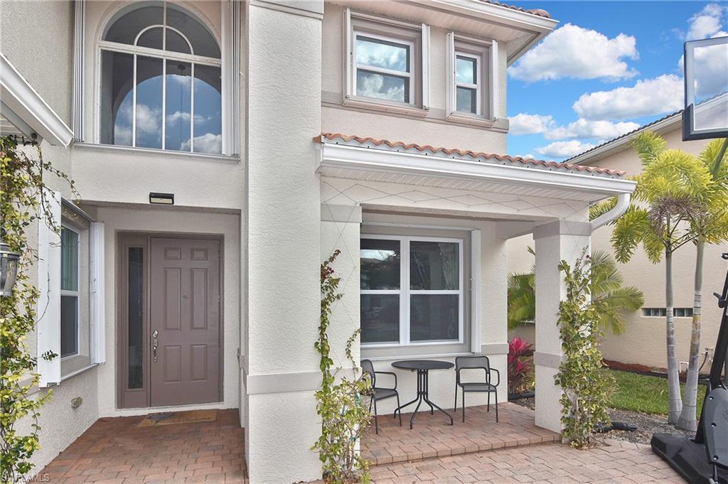 Doorway to property featuring stucco siding and a tiled roof