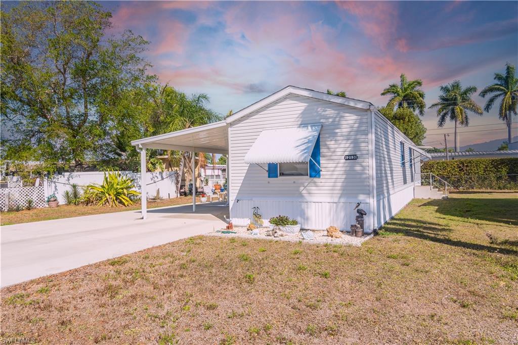 View of side of home featuring a carport and driveway