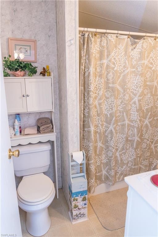 Full bath featuring vanity, wallpapered walls, and shower / bath combination with curtain