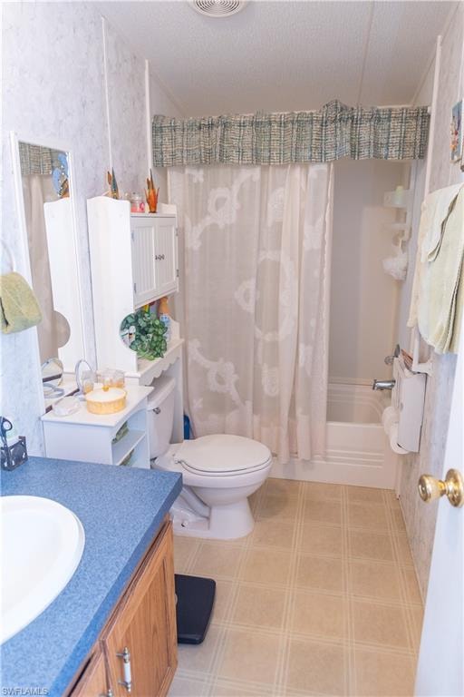 Full bath with vanity, shower / bath combo, and a textured ceiling