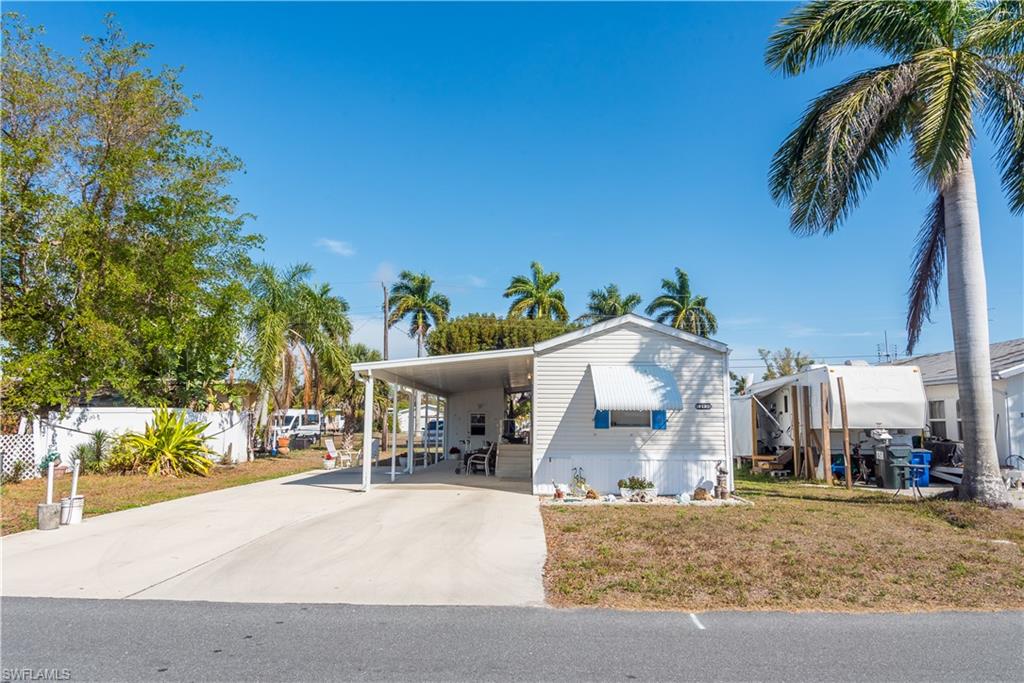Manufactured / mobile home with a carport and driveway