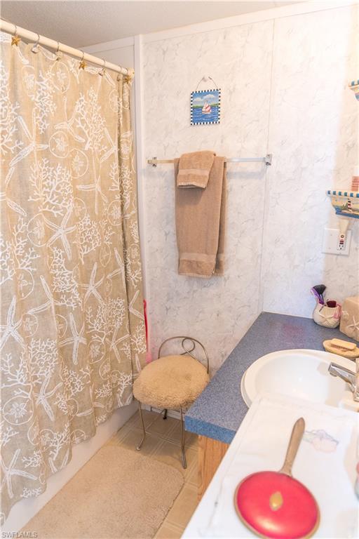 Full bathroom with shower / tub combo and vanity