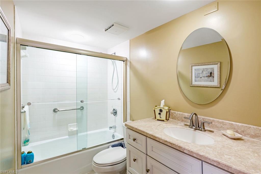 Full bath with vanity and shower / bath combination with glass door