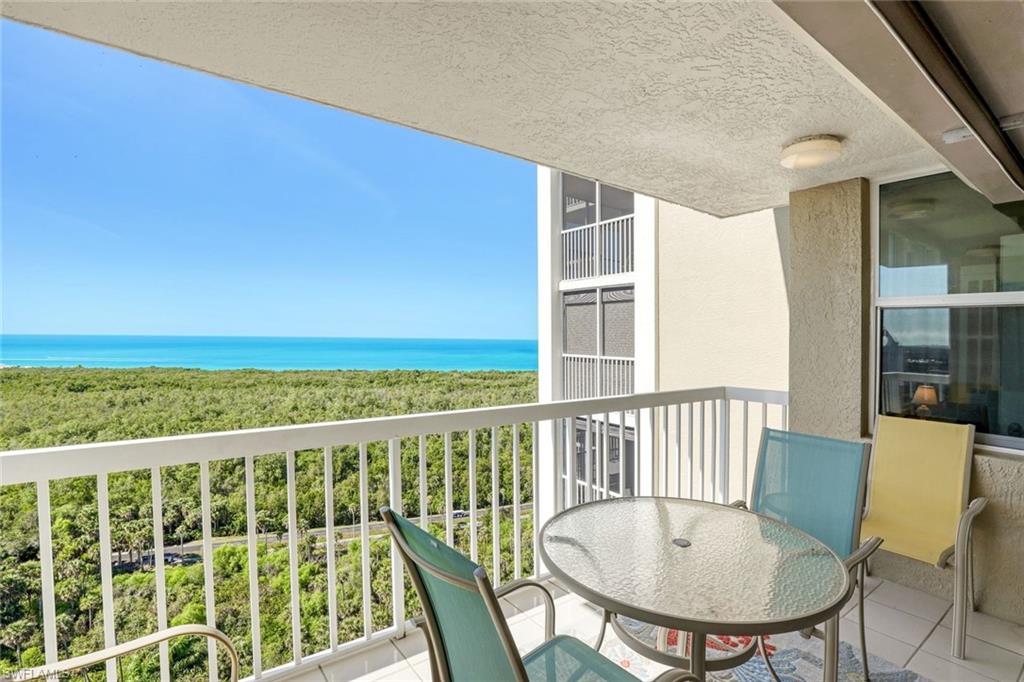 Balcony featuring a water view and outdoor dining area