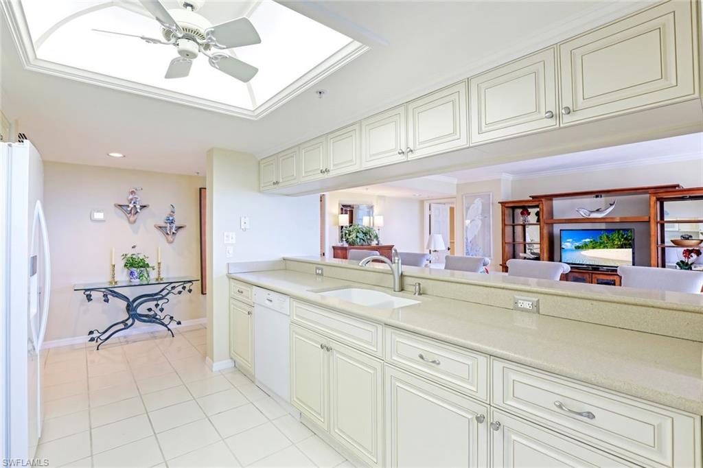 Kitchen with white appliances, a ceiling fan, open floor plan, light tile patterned floors, and recessed lighting