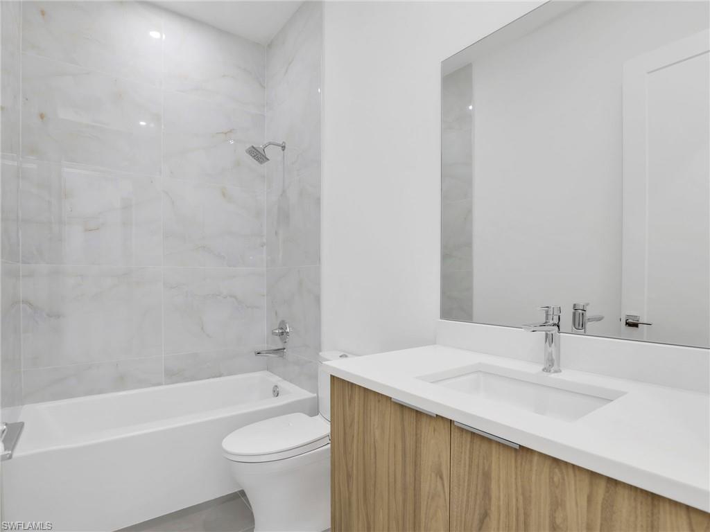 Bathroom featuring vanity and bathing tub / shower combination