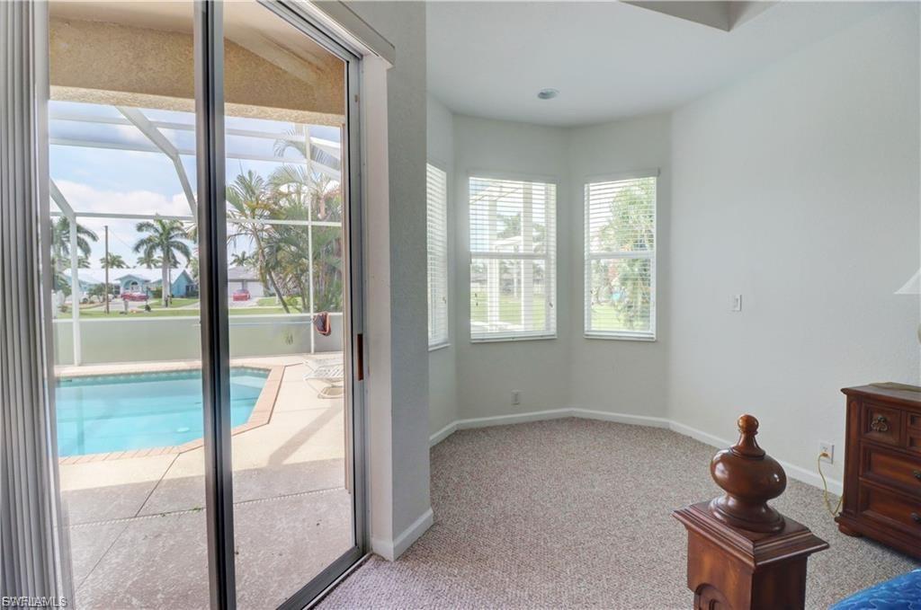 Doorway to outside featuring baseboards and carpet flooring