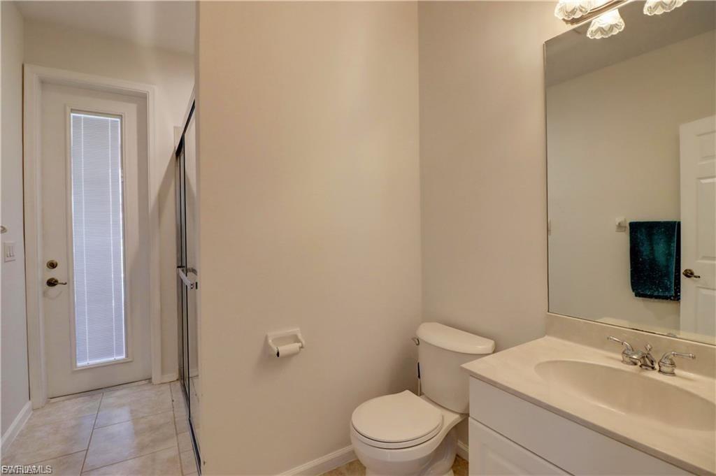 Full bathroom with vanity, a stall shower, and light tile patterned flooring