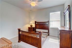 Bedroom featuring ceiling fan and light carpet