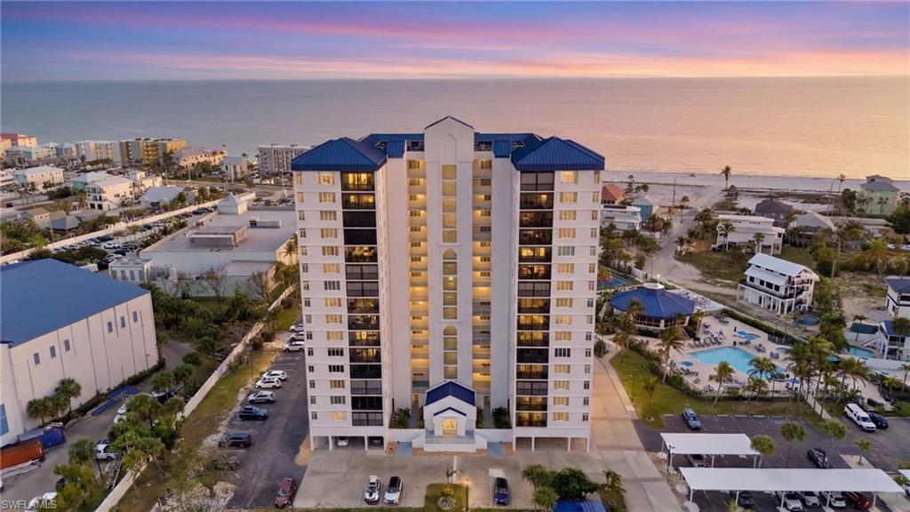 Property at dusk with a water view and a view of apartment building / complex - Virtually Edited Image