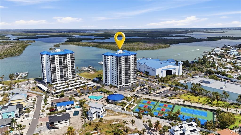 Drone / aerial view of a nearby body of water and apartment complex - Virtually Edited Image