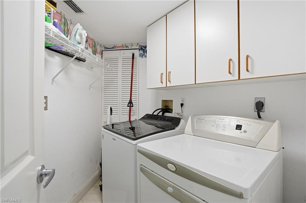 Laundry area with cabinet space and washer and clothes dryer - Virtually Edited Image