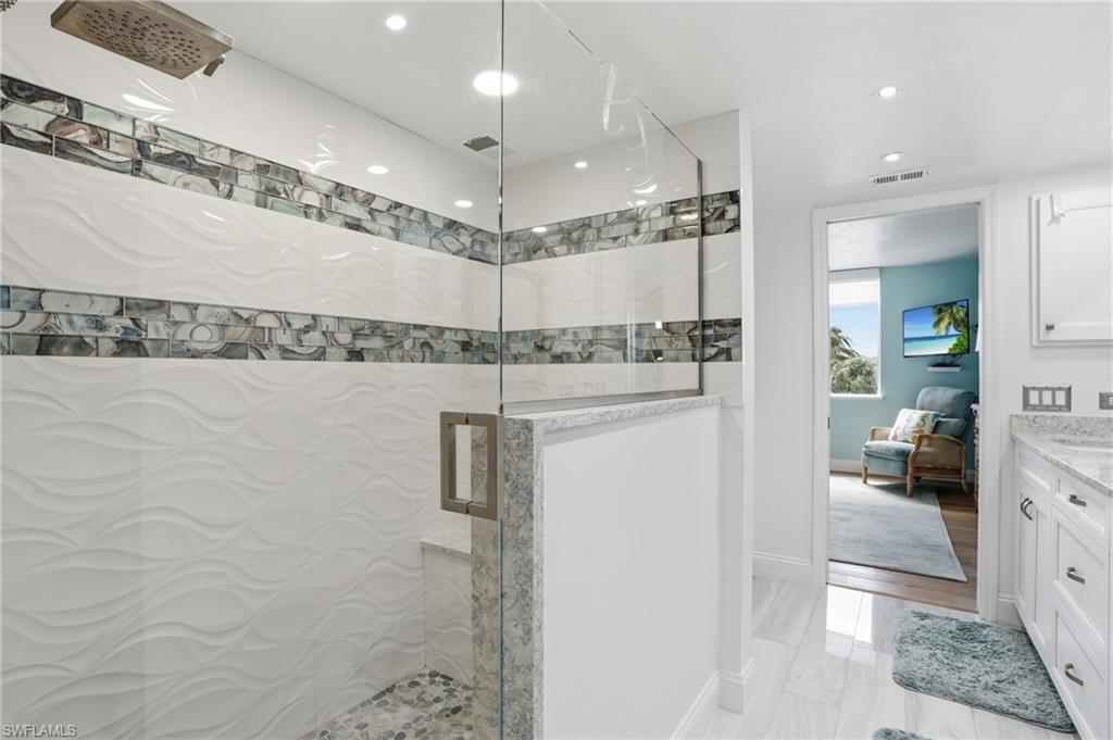 Ensuite bathroom with vanity, a stall shower, and recessed lighting - Virtually Edited Image