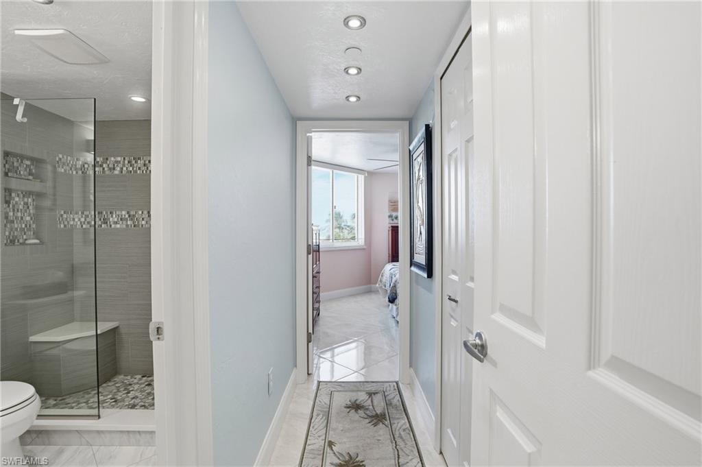 Ensuite bathroom featuring a shower stall and recessed lighting - Virtually Edited Image