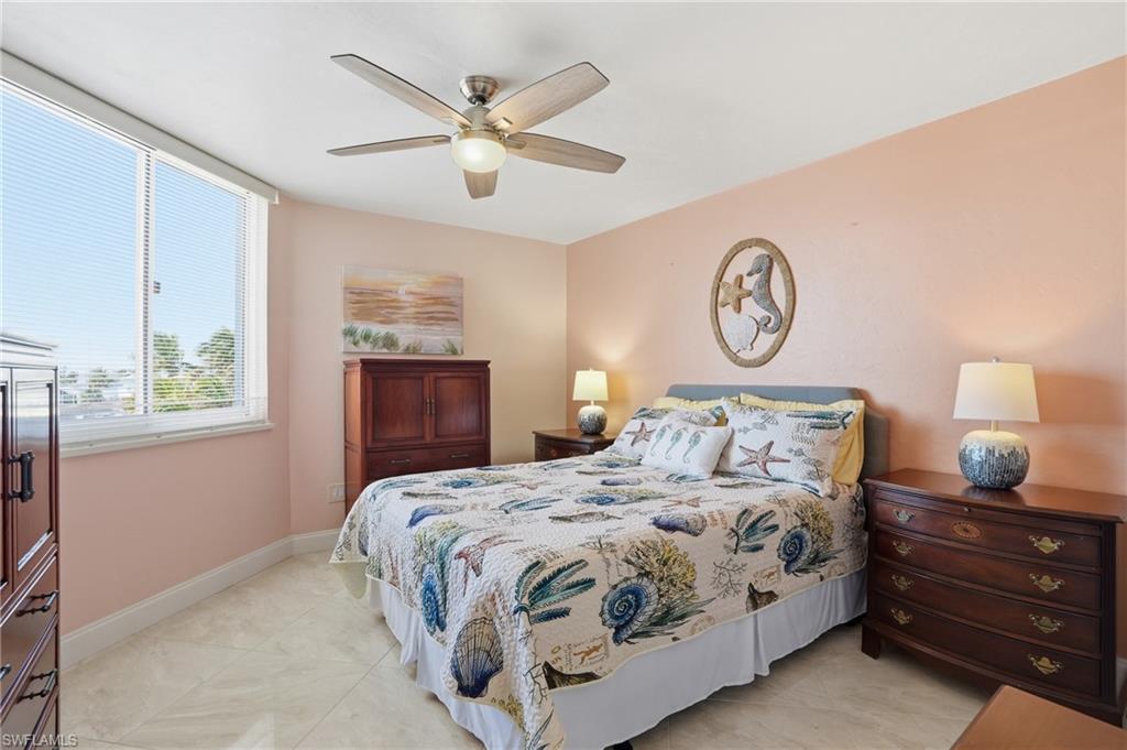 Bedroom with ceiling fan and baseboards - Virtually Edited Image