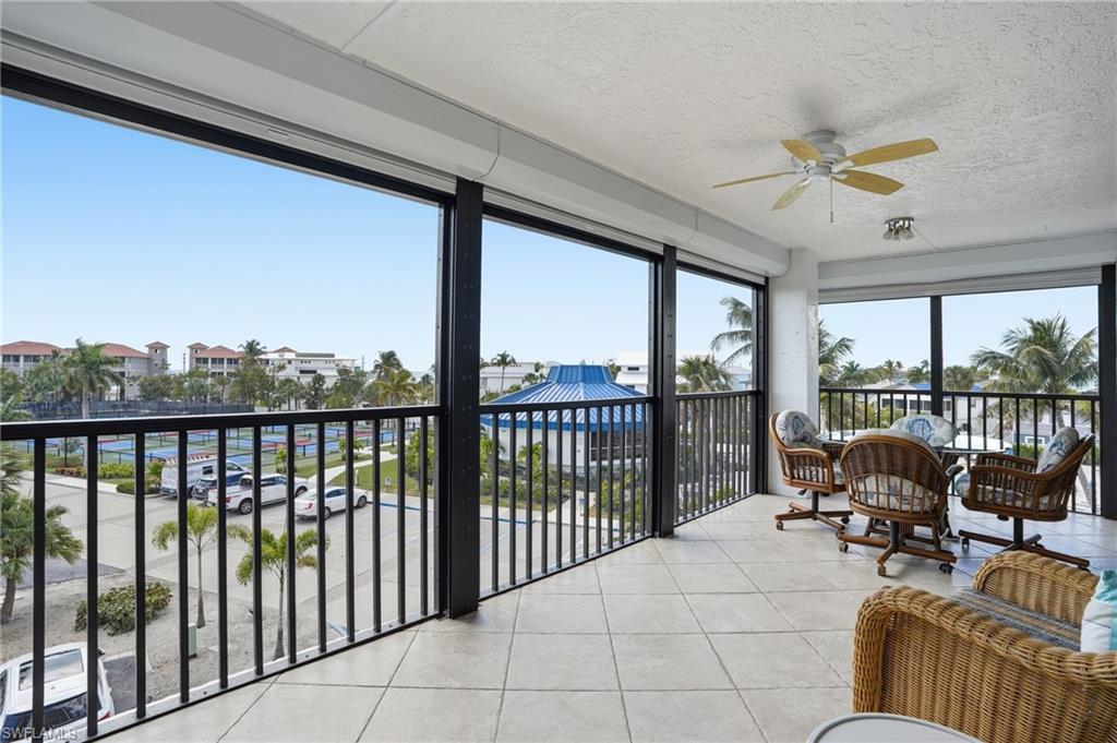 Sunroom / solarium with tile patterned flooring and a textured ceiling - Virtually Edited Image