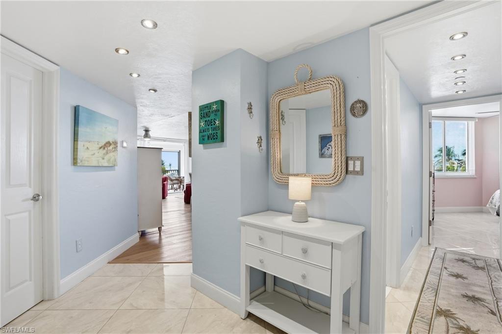 Hall featuring recessed lighting and light tile patterned floors - Virtually Edited Image