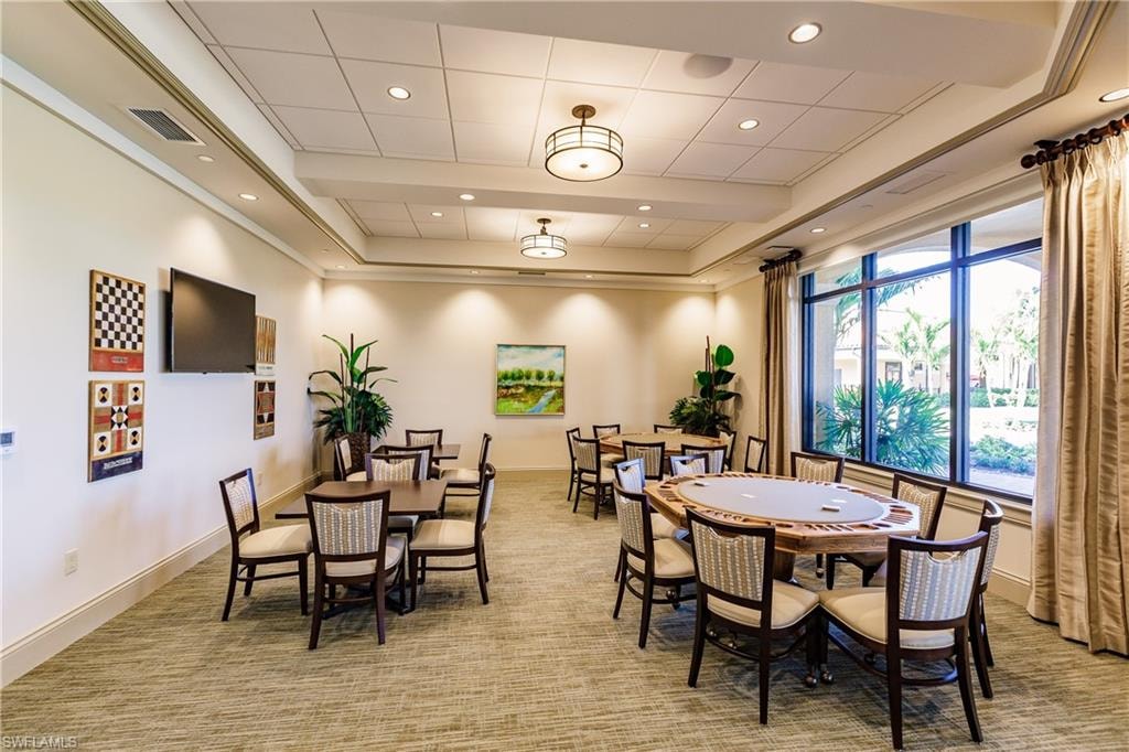 Dining area featuring recessed lighting, light carpet, and beam ceiling