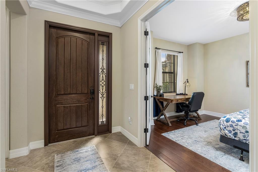 Entryway featuring crown molding and light wood-type flooring
