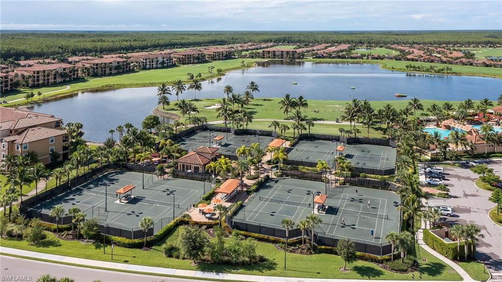 Aerial perspective of suburban area with a nearby body of water and a golf course