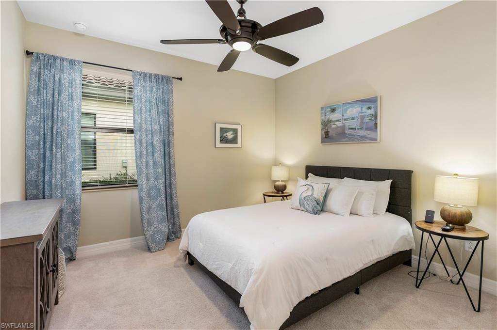 Bedroom featuring light colored carpet and a ceiling fan
