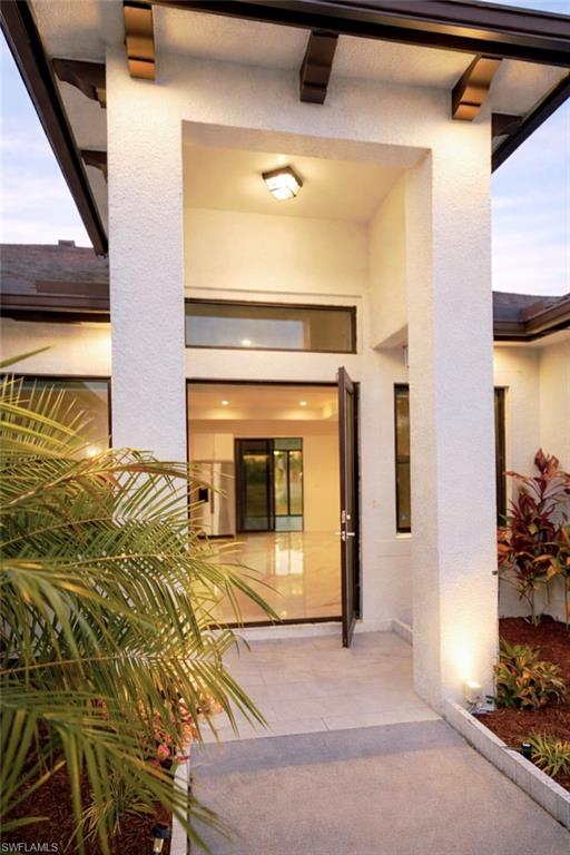 View of exterior entry featuring stucco siding