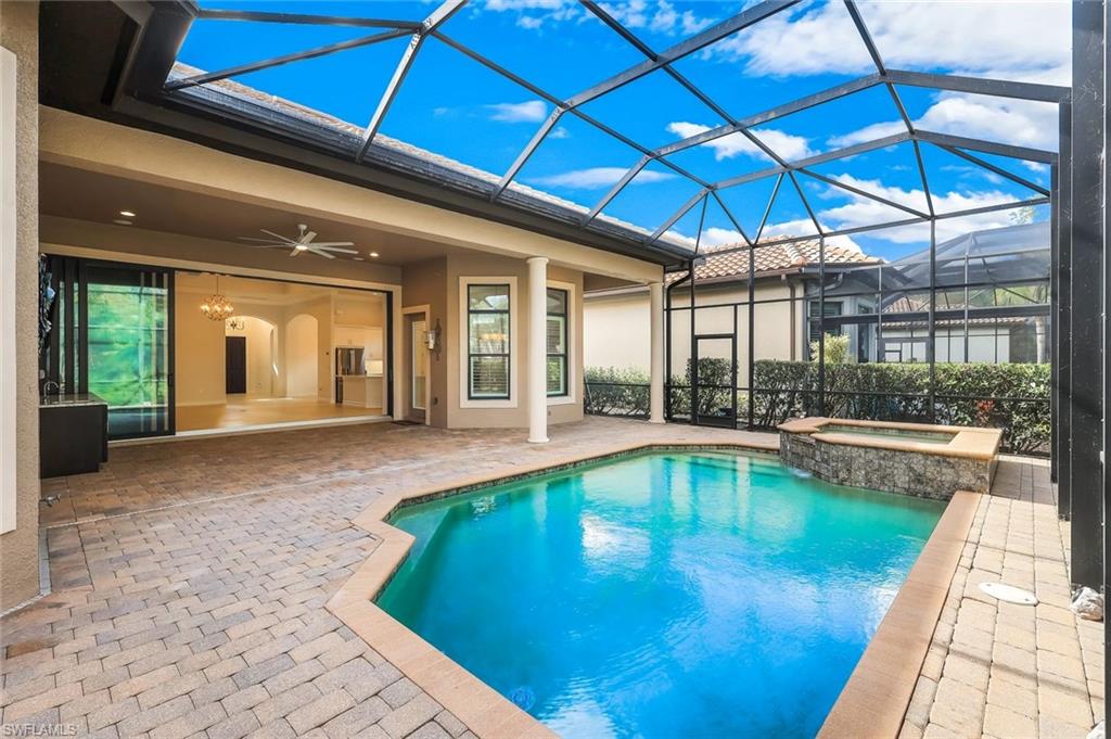 Integrated pool / spa with a patio area, a sunroom, and glass enclosure