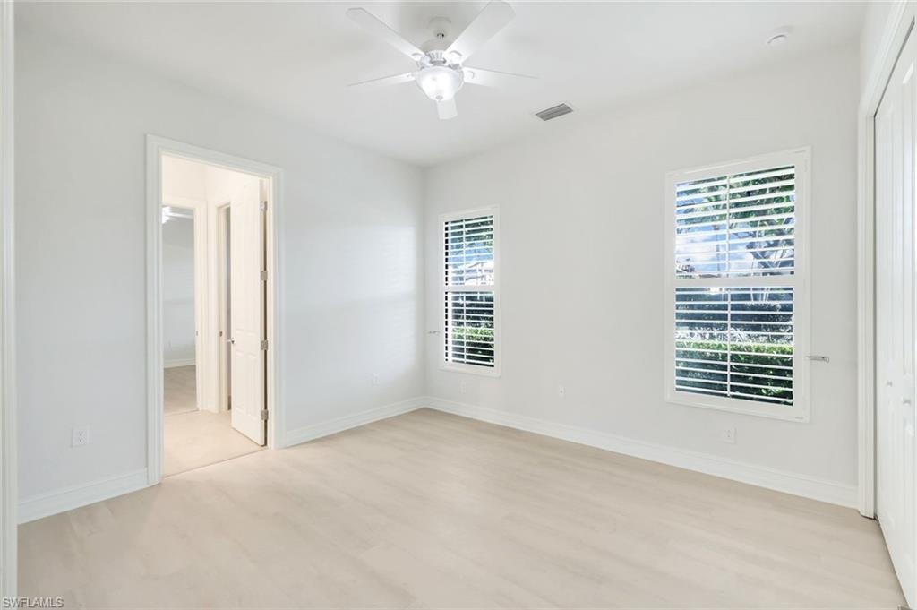 Unfurnished bedroom with ceiling fan, light wood-style floors, and a closet